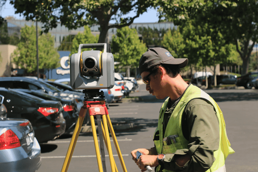 man using survey equipment