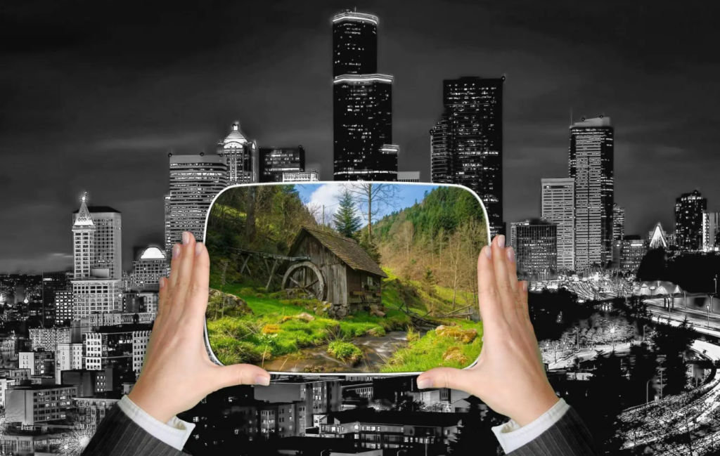 a person holding a screen in front of a city