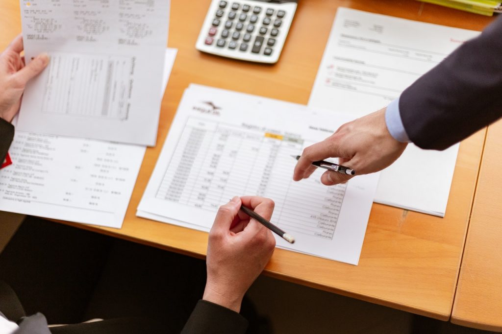 two people looking over a document