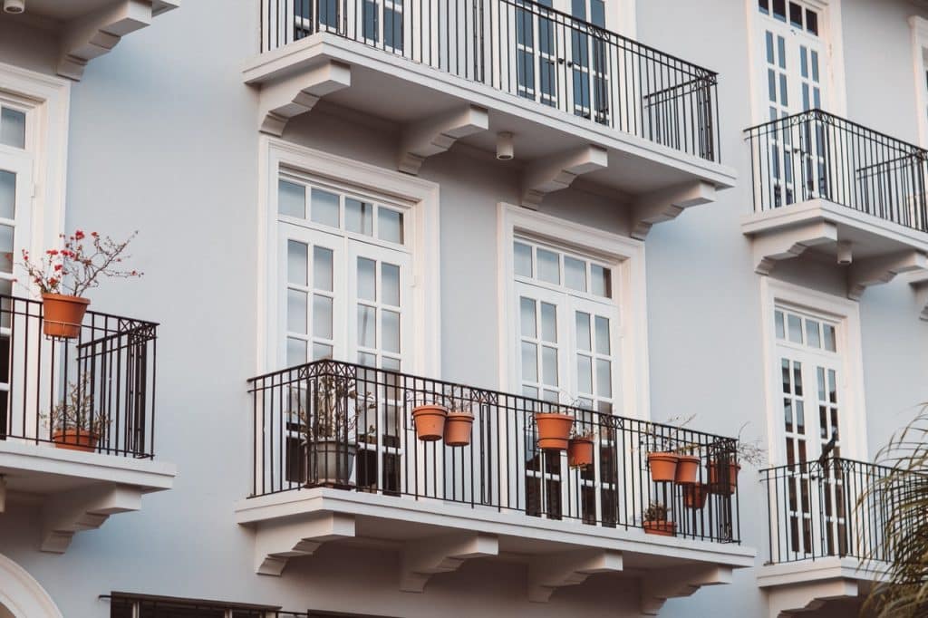 White Concrete Building With Black Metal Railings