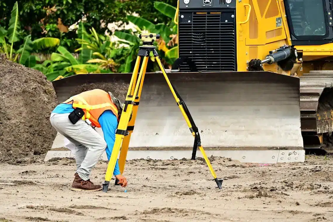 man setting up survey equipment