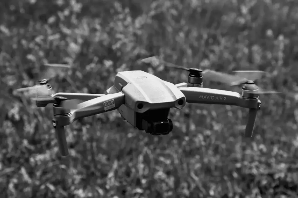 a grayscale of a drone flying 